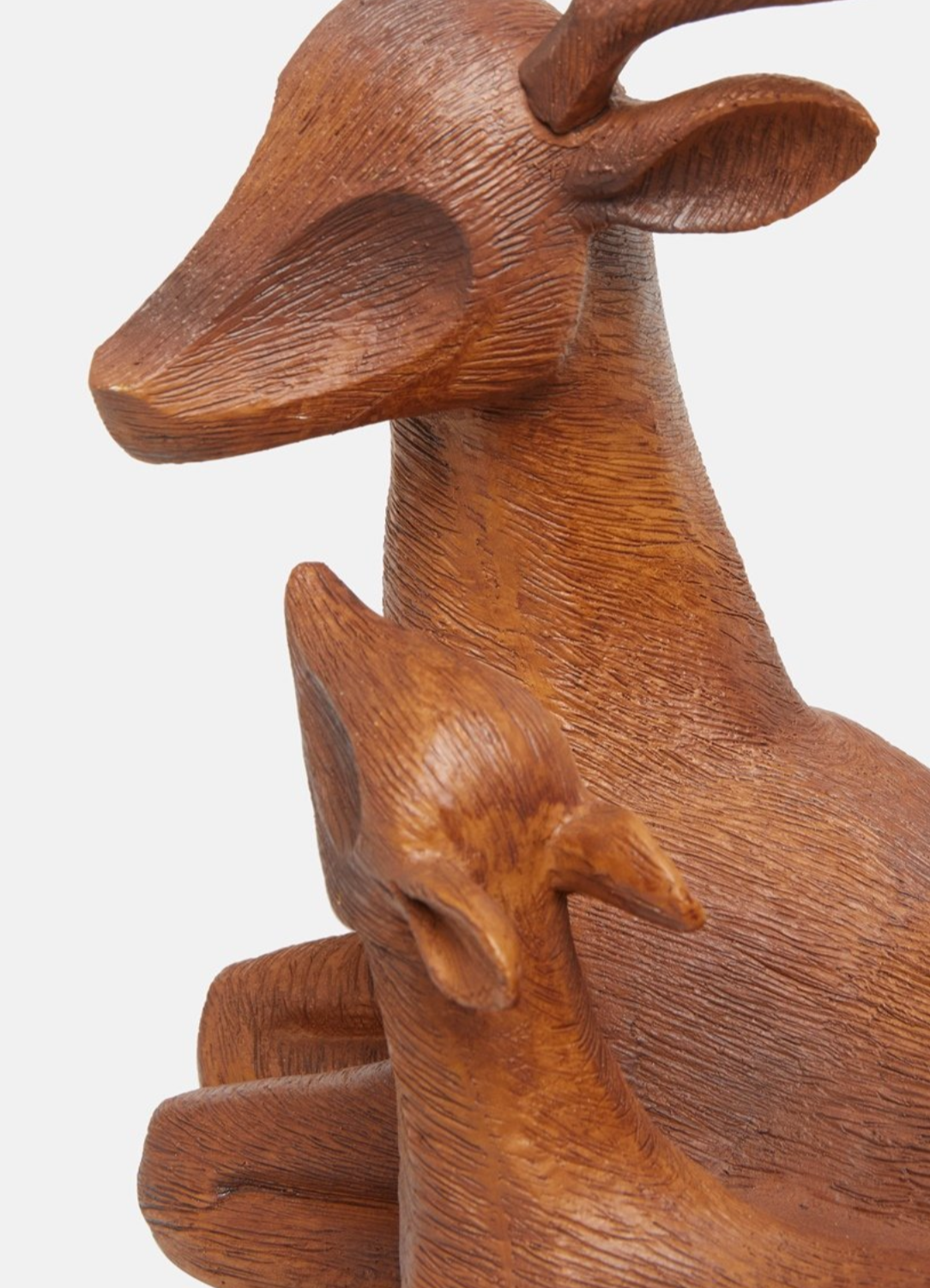 Close-up of the Lawrence Grey deer decorative figure showing wood-textured details.
